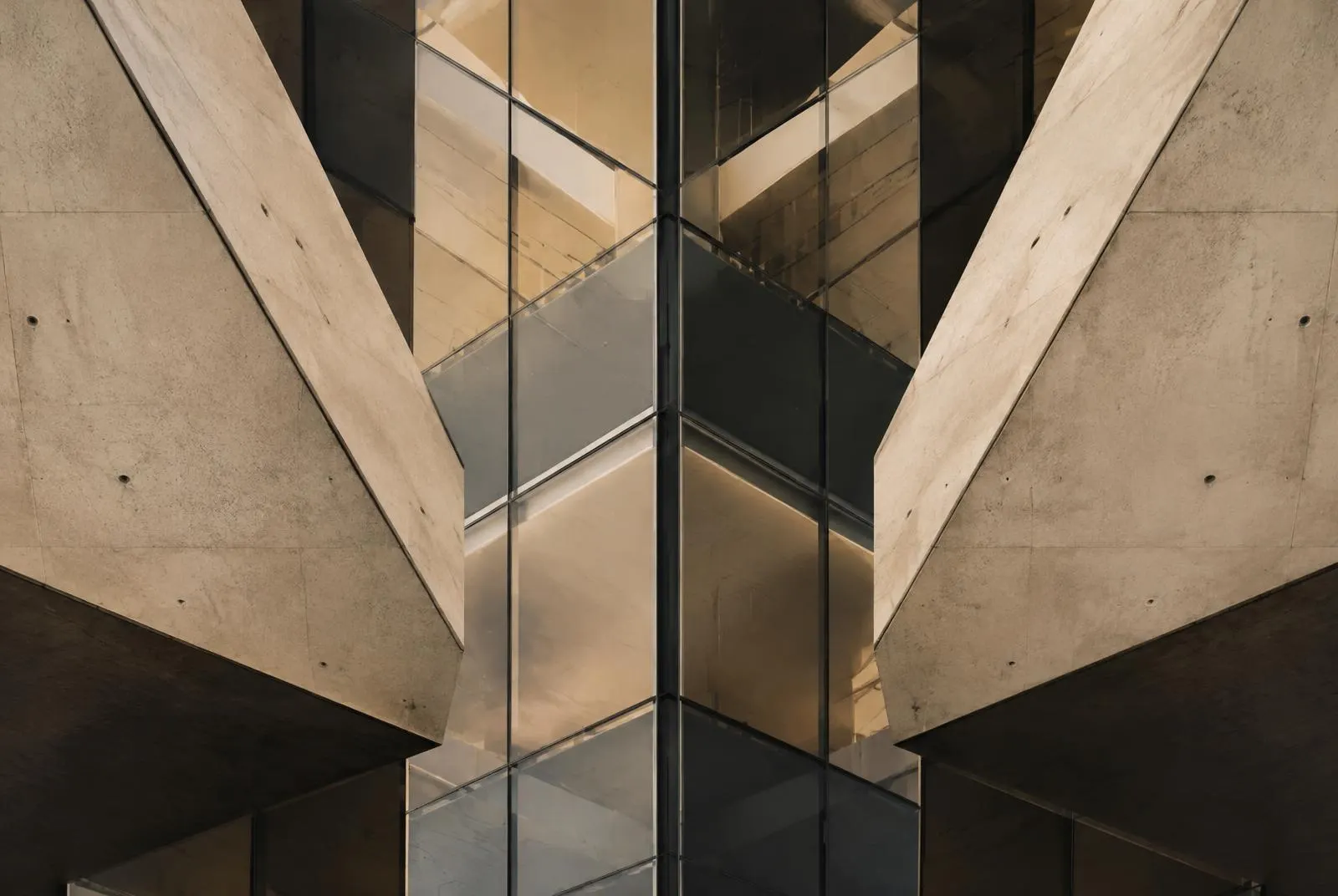 Symmetrical intersecting concrete and glass architectural forms